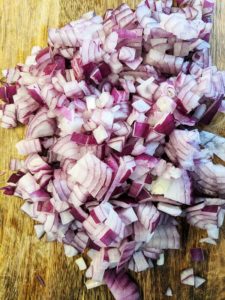 Chopped red onions on a wooden board