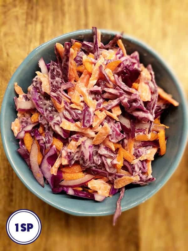A close up picture of a bowl of coleslaw