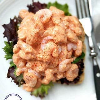 Close up of a prawn marie rose open sandwich on a white plate