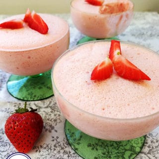 3 pink desserts with strawberries on top