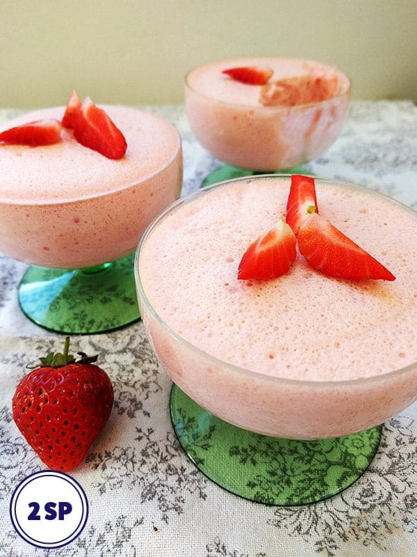 3 pink desserts with strawberries on top