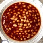 A bowl of baked beans in bbq sauce