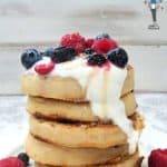 A tower of crumpets topped with yogurt and fruit