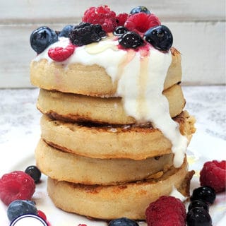 A tower of french toast crumpets topped with yogurt and fruit