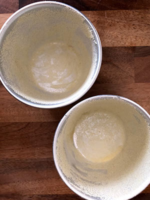 Two greased mini pudding bowls.
