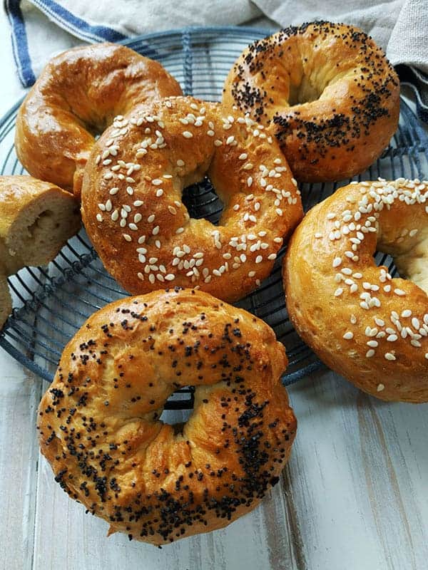 A close up of bagels on a circular cooling rack