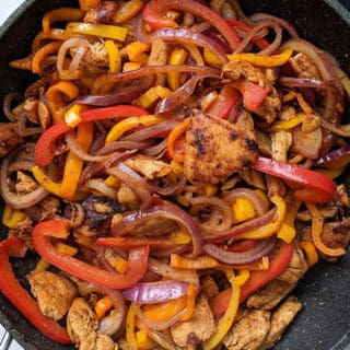 A close up of a skillet of fajita mix