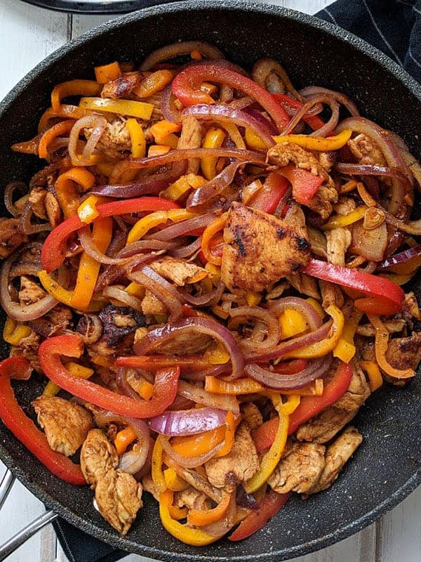 A close up of a skillet of fajita mix