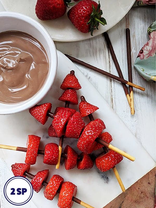 Some strawberry kebabs with chocolate dipping sauce