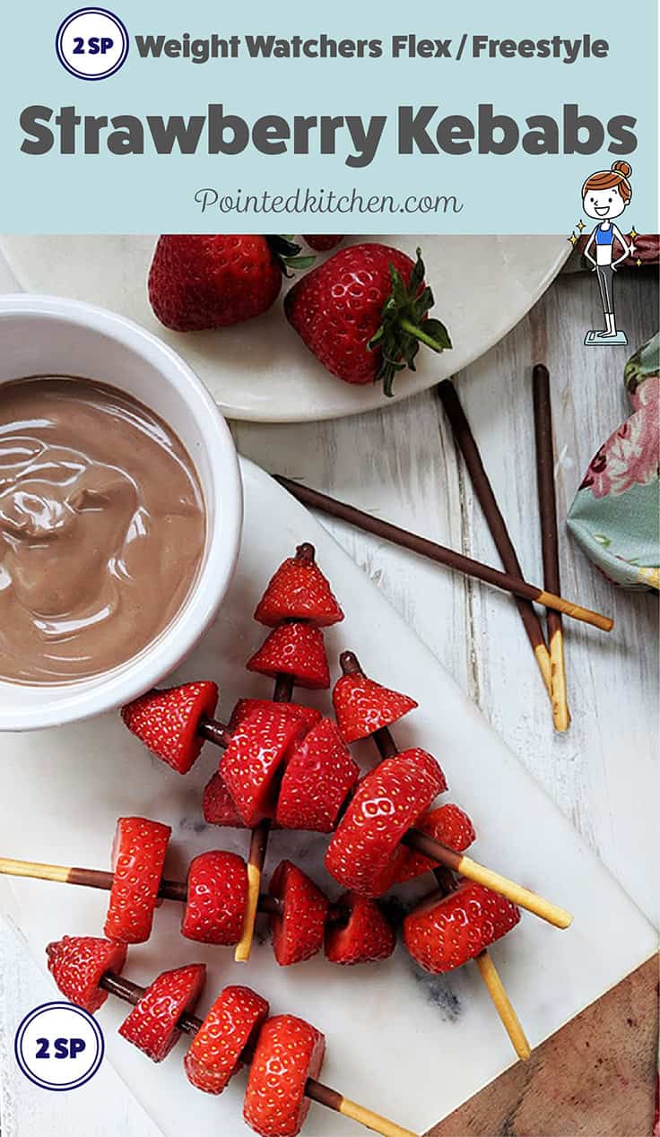 Strawberry kebabs on a board with chocolate dipping sauce