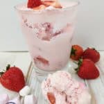 A glass of fluff with strawberries and marshmallows