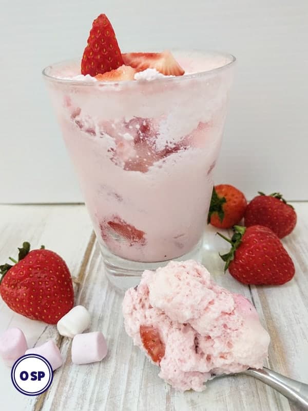 A glass of fluff with strawberries and marshmallows