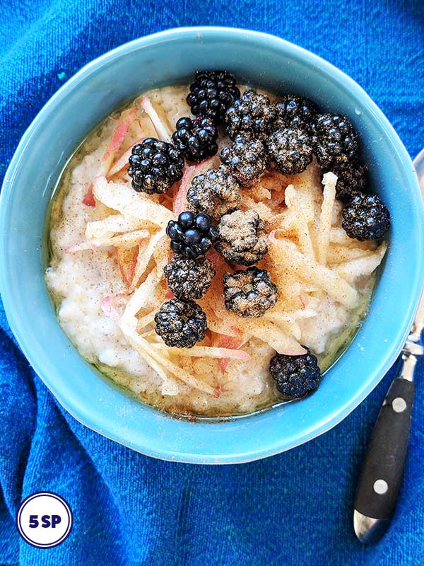 A blue bowl of Blackberry & Apple Porridge