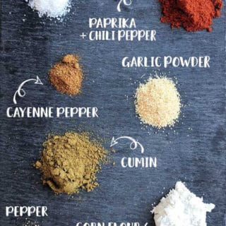 Spices for fajita seasoning mix on a black slate