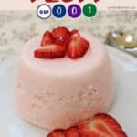 A pink dessert with sliced strawberries