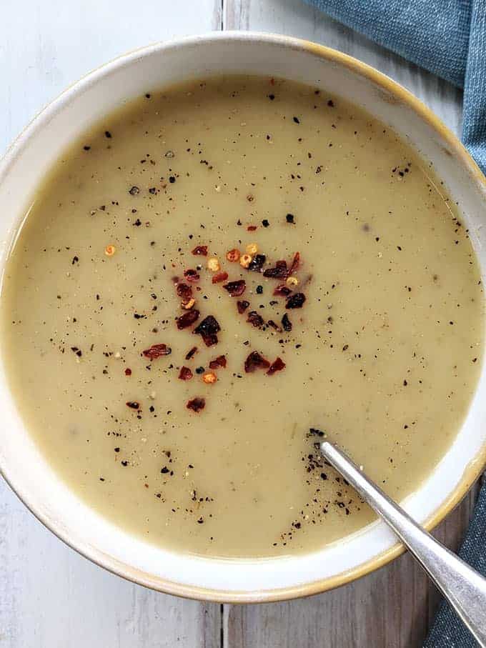 a bowl of spiced parsnip soup on a white table