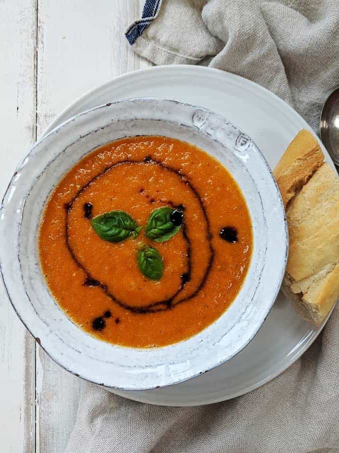 A bowl of tomato soup with a drizzle of balsamic vinegar