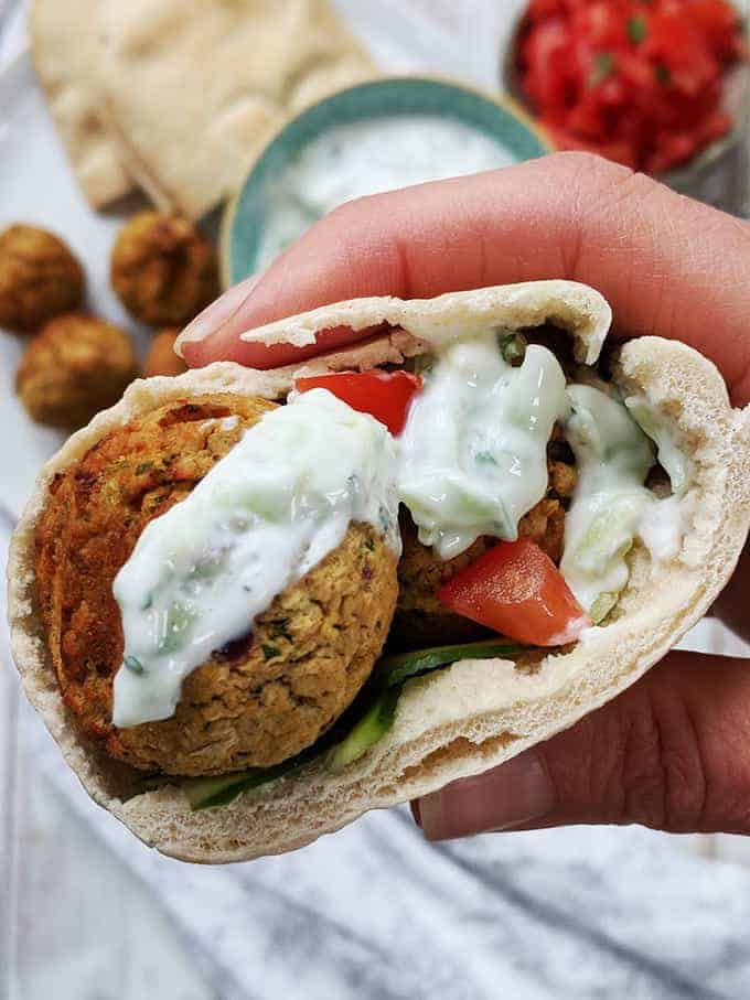 Falafel in a pitta bread with tzatziki and salad