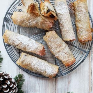 A tray of filo mince pies on a white table.