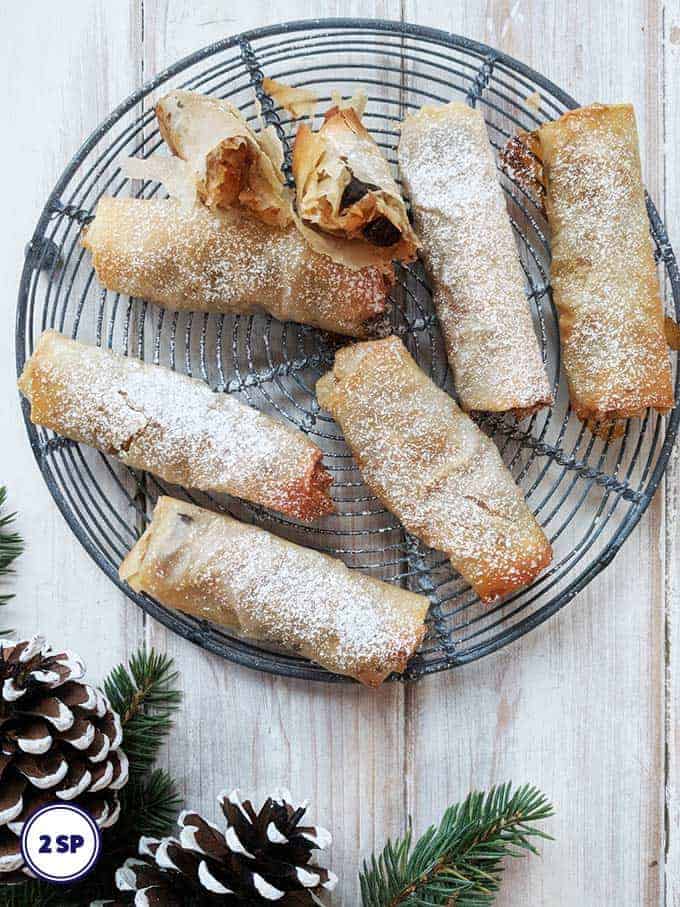 A tray of filo mince pies on a white table.