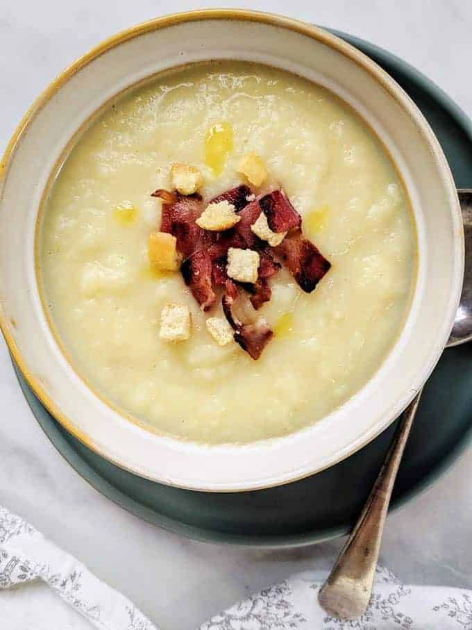 A bowl of celeriac soup with crispy bacon and croutons