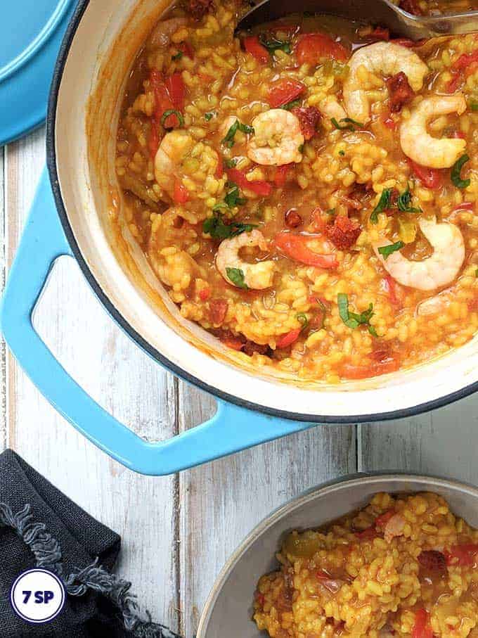 A dish of shrimp, chorizo and red pepper paella