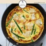 An asparagus and brie frittata on a white table