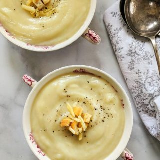 Two bowls of cauliflower cheese soup
