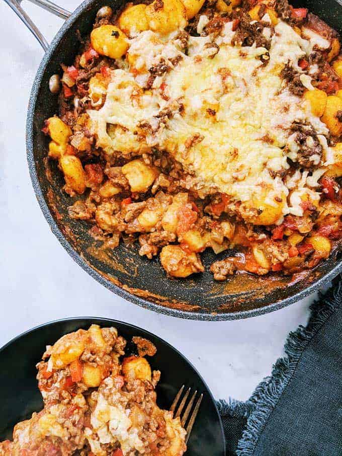 A skillet of spicy ragu gnocchi on a table