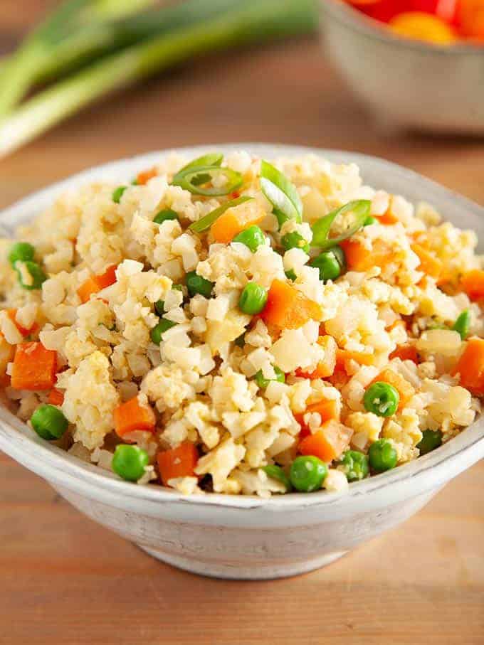 Egg fried cauliflower rice in a white bowl