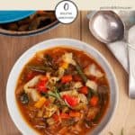A bowl of zero point cabbage soup on a wooden table | weight watchers