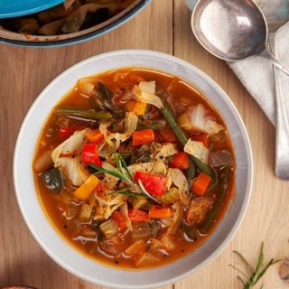 A bowl of zero point cabbage soup on a wooden table | weight Watchers