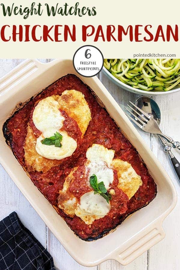 A casserole dish of chicken parmesan on a white table