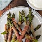 A plate of asparagus wrapped in Prosciutto