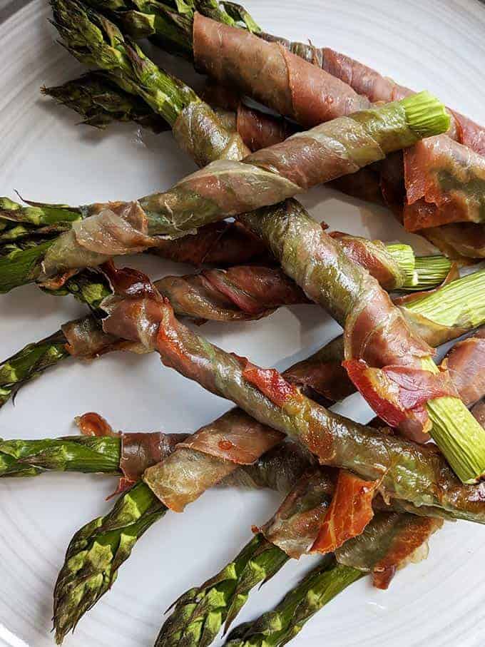 A close up shot of some prosciutto wrapped asparagus