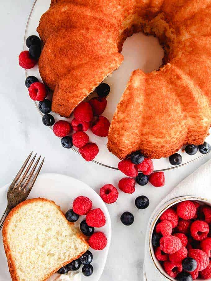 A top down photo of pineapple angel food cake on a white table