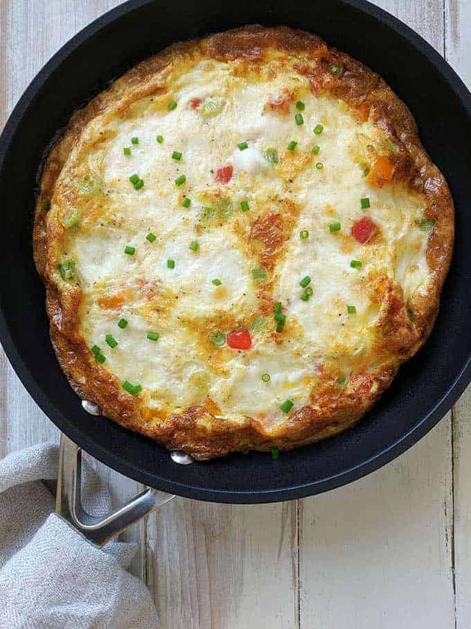 A skillet of sweet pepper frittata with mozzarella