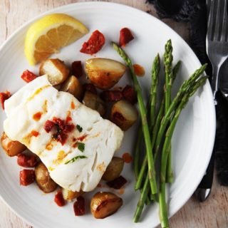 A close up picture of Cod & Chorizo with new potatoes and asparagus