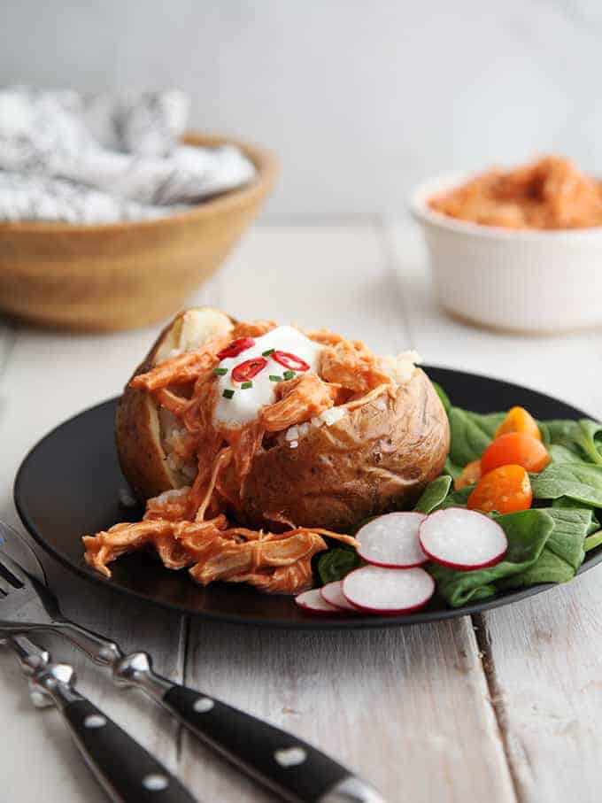 A jacked potato topped with buffalo chicken dip