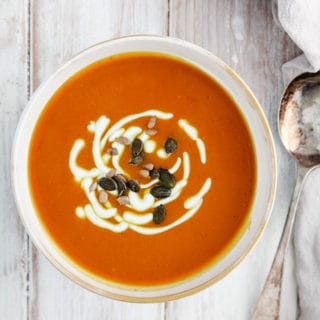 A bowl of weight watchers curried butternut squash soup on a white table