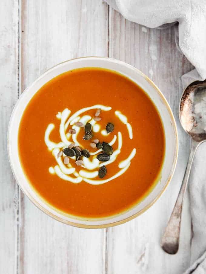 A bowl of weight watchers curried butternut squash soup on a white table