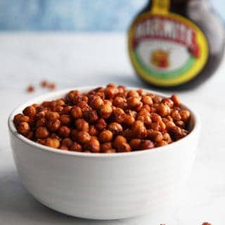 A bowl of chickpeas with a tub of marmite
