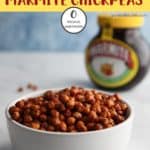 A bowl of marmite chickpeas with a tub of marmite at the back