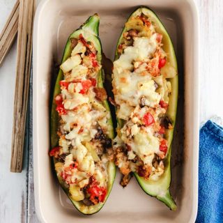 A dish of stuffed zucchini on a white table