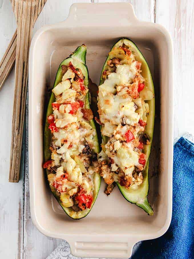 A dish of stuffed zucchini on a white table