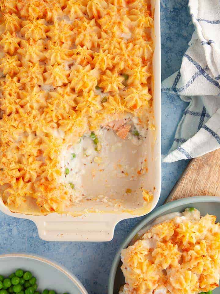 A dish of fish pie on a blue table