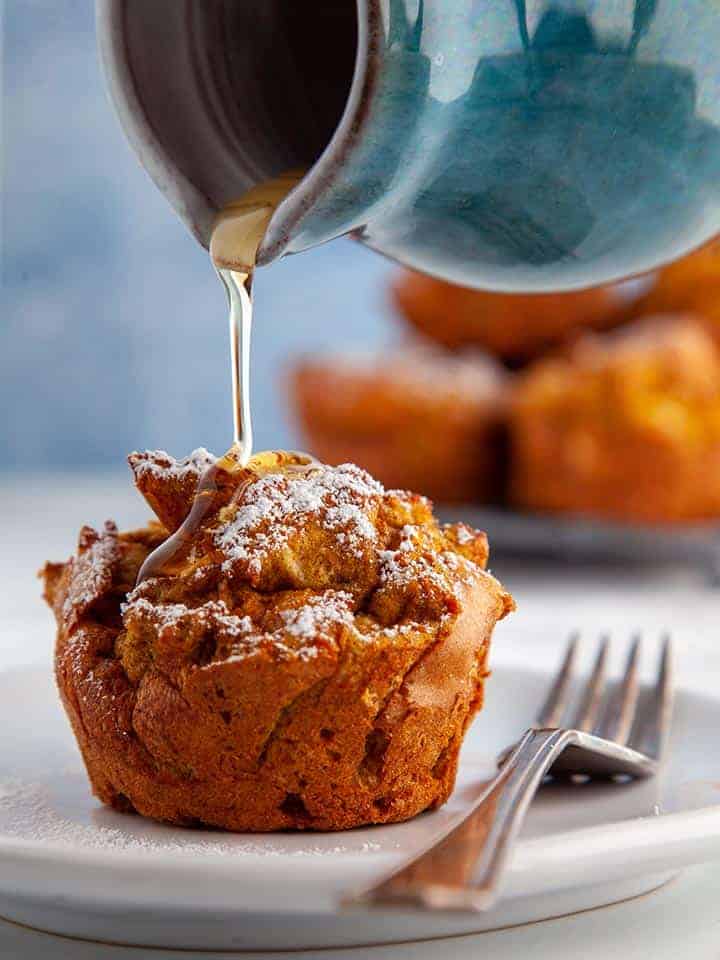 Syrup being poured over a pumpkin spiced french toast muffin