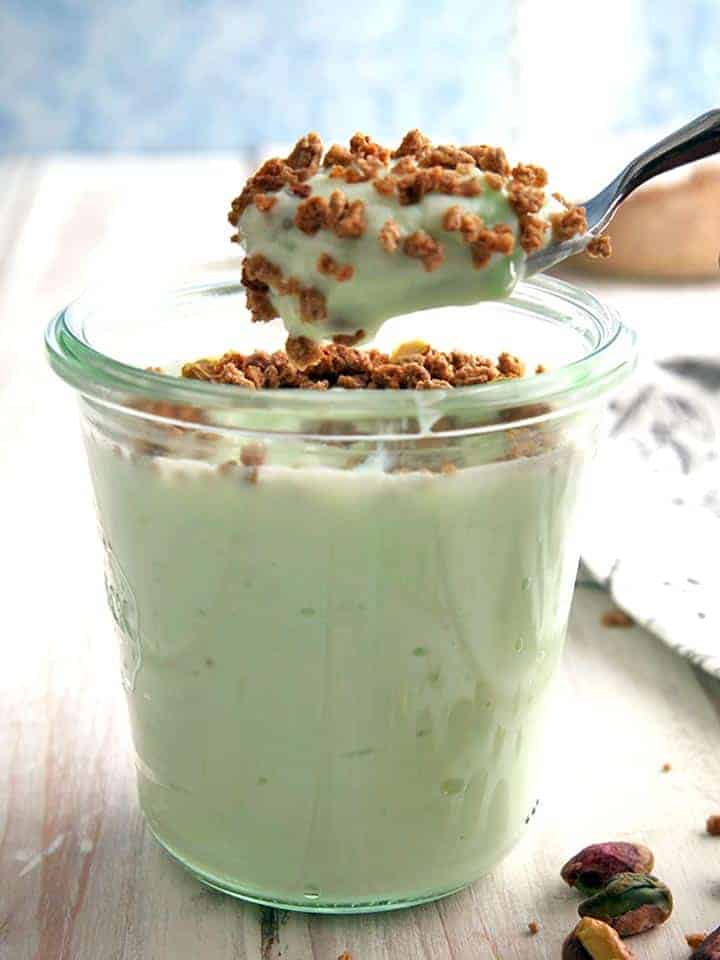 A spoonful of pistachio crunch dessert