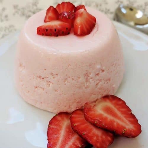 A Weight Watchers Fluff dessert on a white plate with strawberries