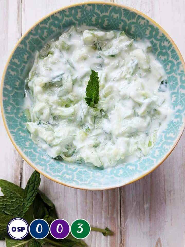 A dish of tzatziki on a white table